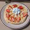 Waffles with whipped cream and strawberry